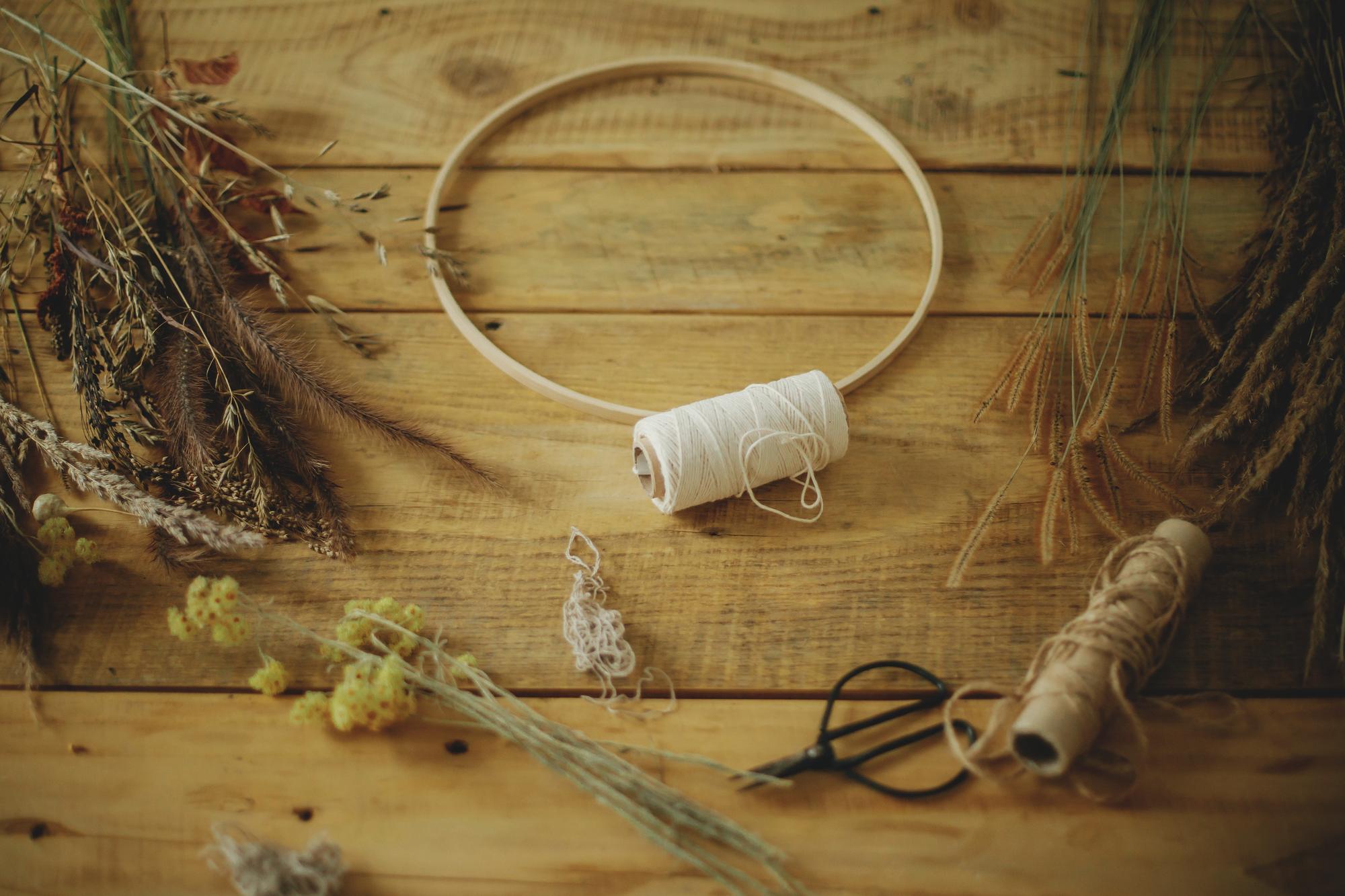 atelier workspace with thread spools and embroidery hoop